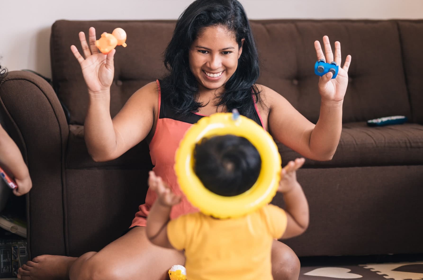 A caring woman and children happily play with toys, illustrating the supportive role of nanny services in child development.